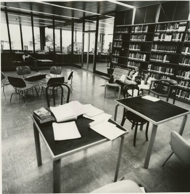 View of the library with a student studying at a table