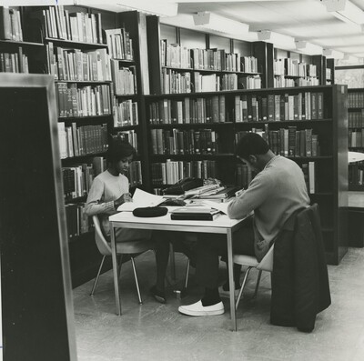 Two black students studying in burling. This photo, and other Black Expressions photos were in a brochure CBS created to let prospective Black students what to expect from Grinnell College.