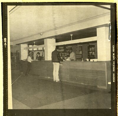 Negative containing photo of David Weston working at the circulation desk in Burling circa 1983.