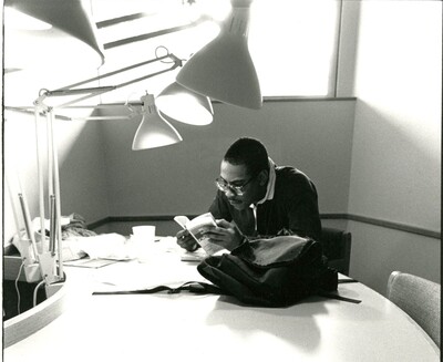 Photo of student studying in Burling basement with a book