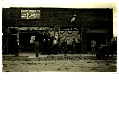  Several people standing in front of the Hrabak and Gardner Auto Company auto service garage.