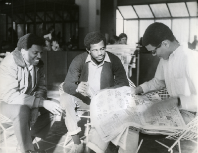 Three African American students sit in the Forum. 