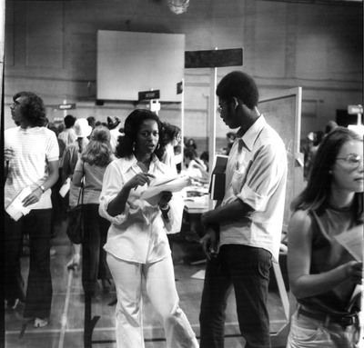 Two students chat during registration.The Black Manifesto’s stated that “We demand that this administration establish a Black community with no less that 200 representatives taken from all walks of life of Black people, and that the responsibility of for the establishment of this community be co-shared by the present black community.”