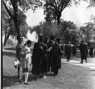 Students and family at the 1972 Commencement. Robed graduates left to right: LuVernne Vann; Linda Copeland Rozell; Alan D. Wheat; Carl Brennan. Many of the students were members of CBS.