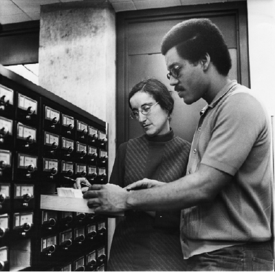 David Weston, class of 1973, and Mary Gae Wyly, reference librarian, looking through the library catalog. Wyly was reportedly one of the librarians who worked on reorganizing and expanding the Black Library.